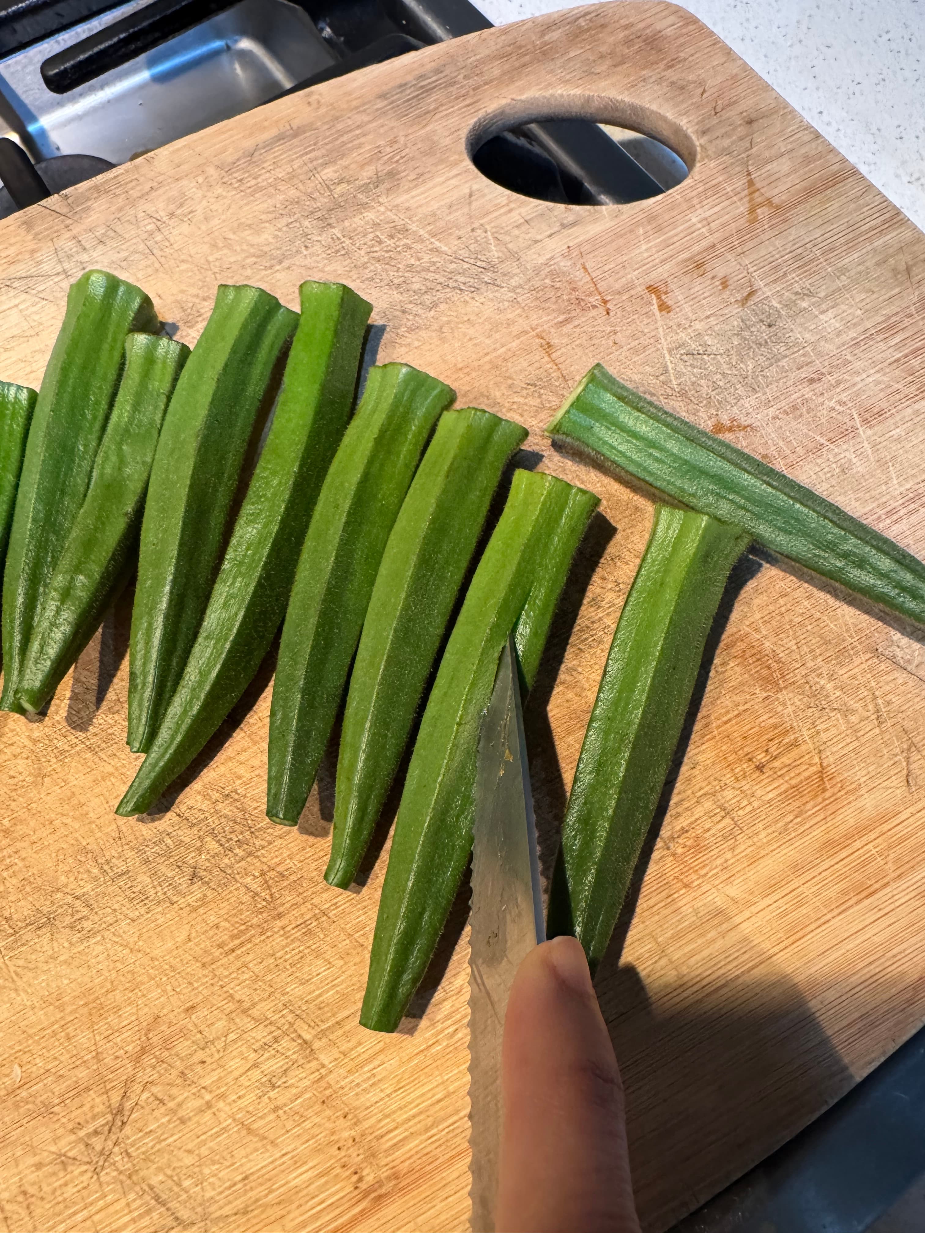 Trim the stems and slit each pod lengthwise.